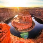 brown rock formation beside body of water during daytime