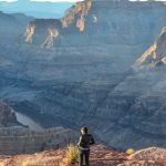 woman standing on rock mountain during day time